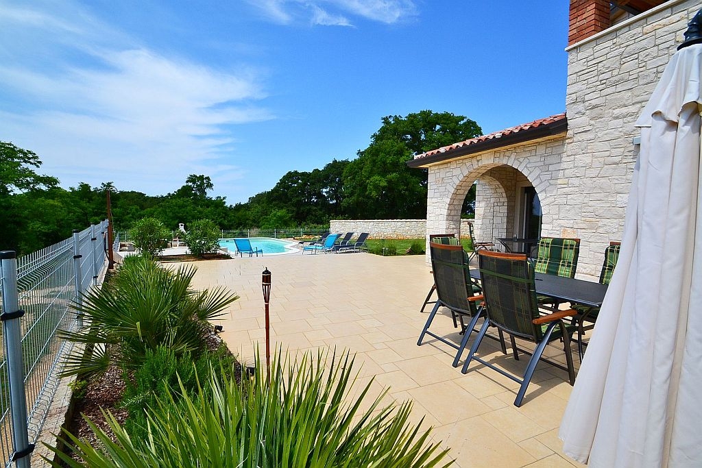 Covered terrace with pool view